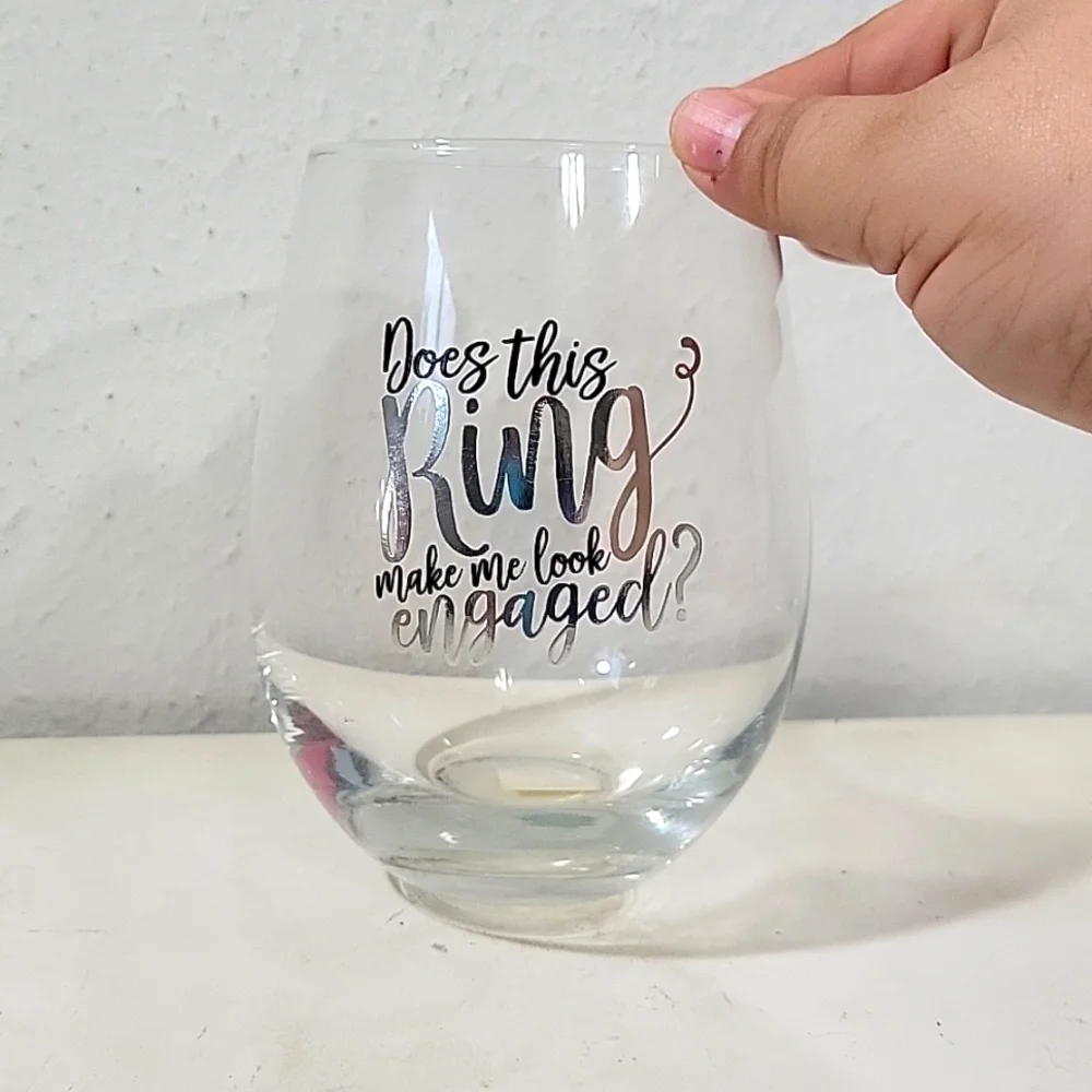 EUC stemless wine drinking glass that says does this ring make me look e…